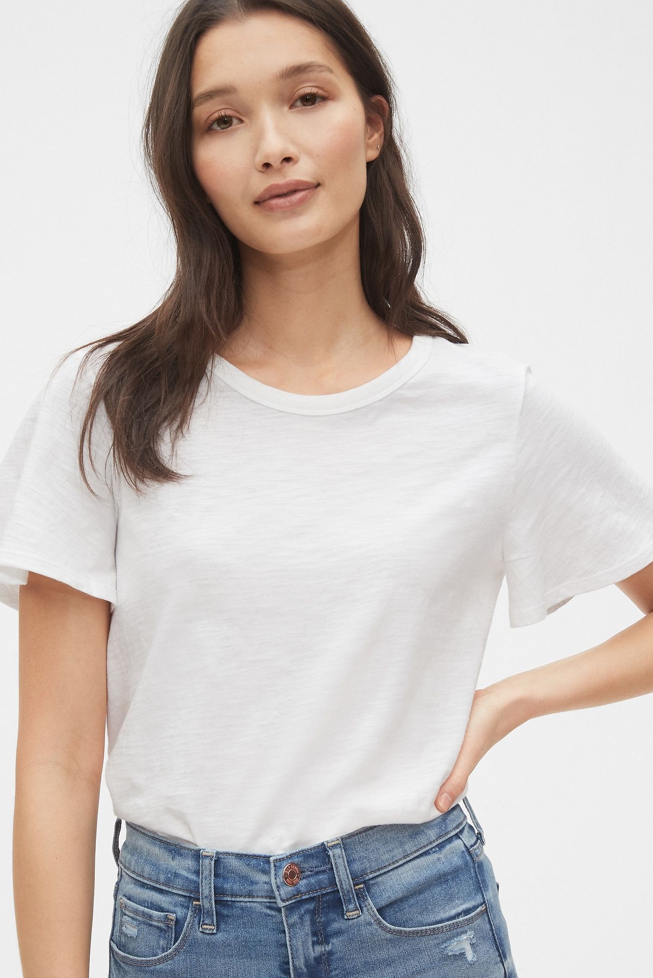 Woman wearing white t-shirt and jeans