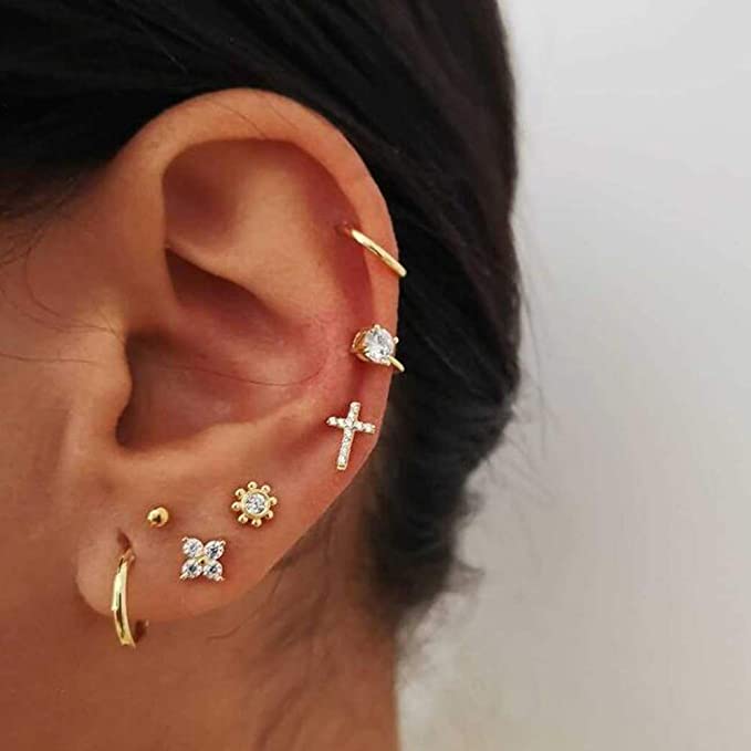 Close-up of woman wearing Missgrace Gold Vintage Cross Circle Earrings