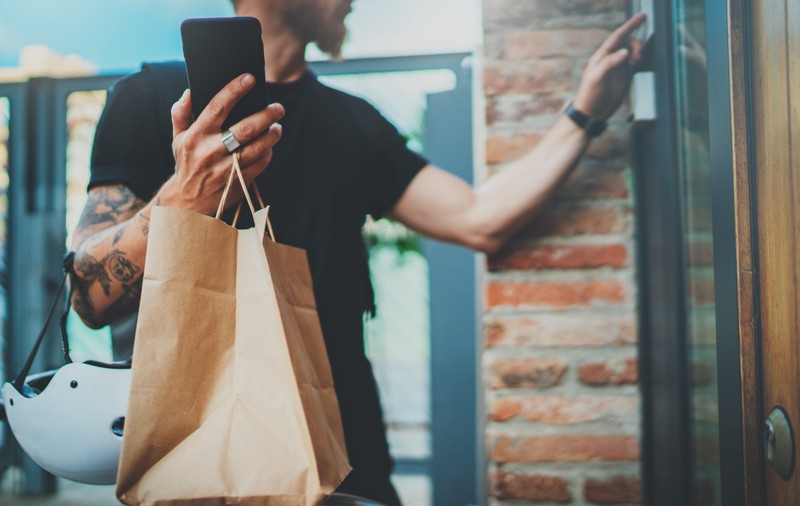 Man holding a bag of delivery food