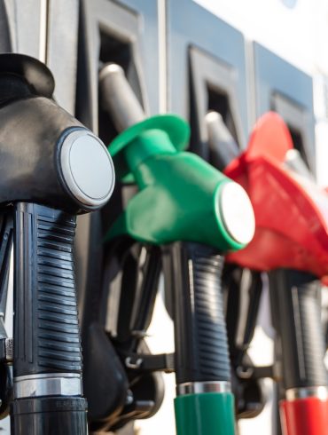 Colorful gas pump handles in a row