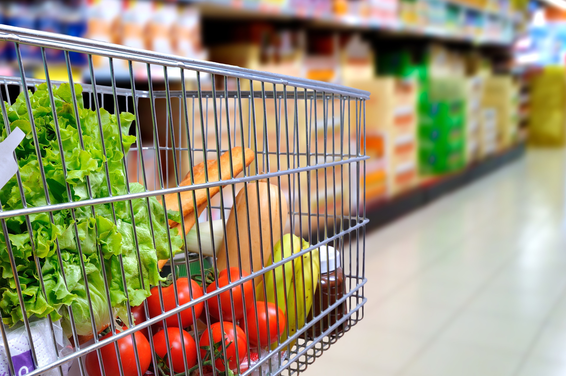 Pushing a cart of groceries in a store