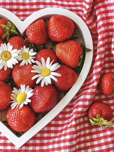 Container in shape of heart and filled with strawberries