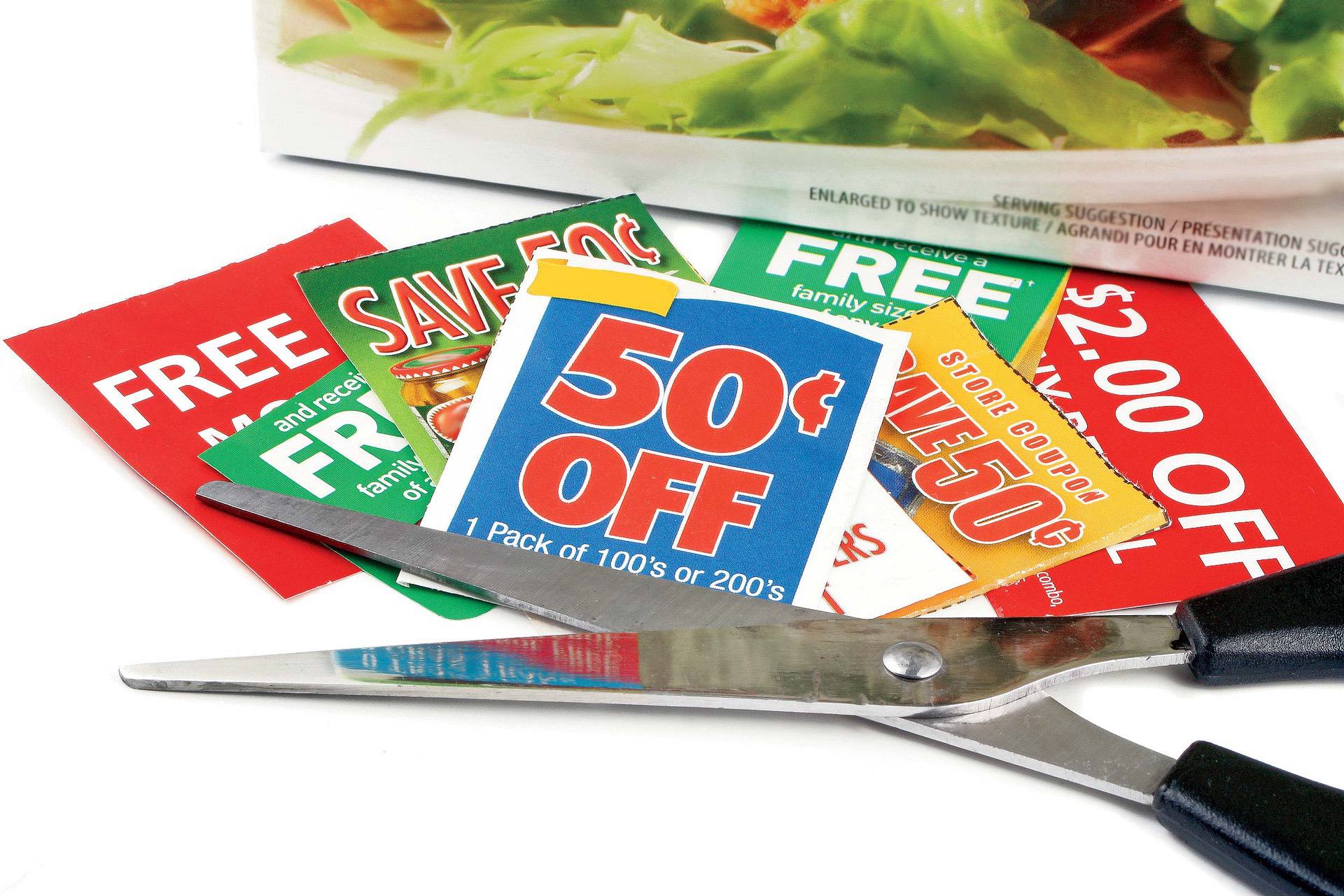 Pair of scissors next to cut-out coupons